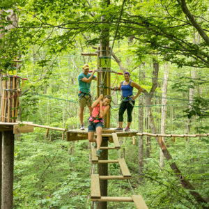 Girl tackles obstacle while parents watch
