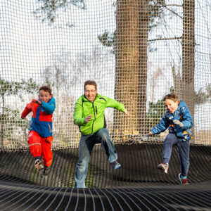 Family having fun on Go Ape outdoor adventure ropes course Chicago