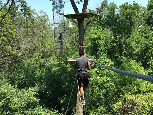 Man enjoying Go Ape outdoor adventure ropes course Chicago