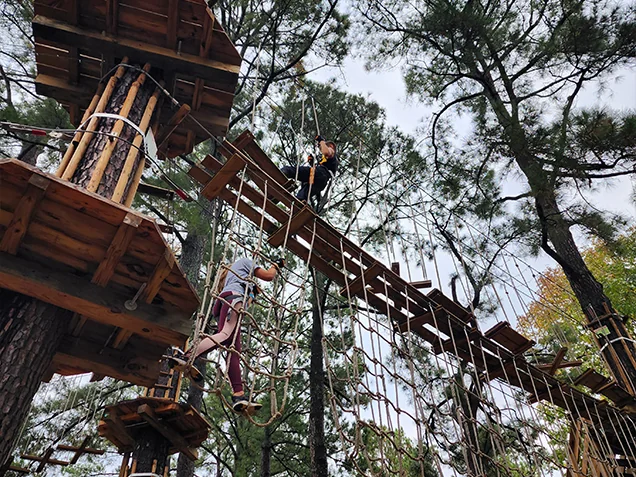 Climbers having fun at Go Ape outdoor adventure ropes course memphis