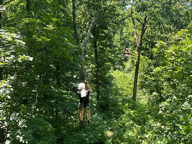 Woman ziplining at Go Ape zipline Kansas City