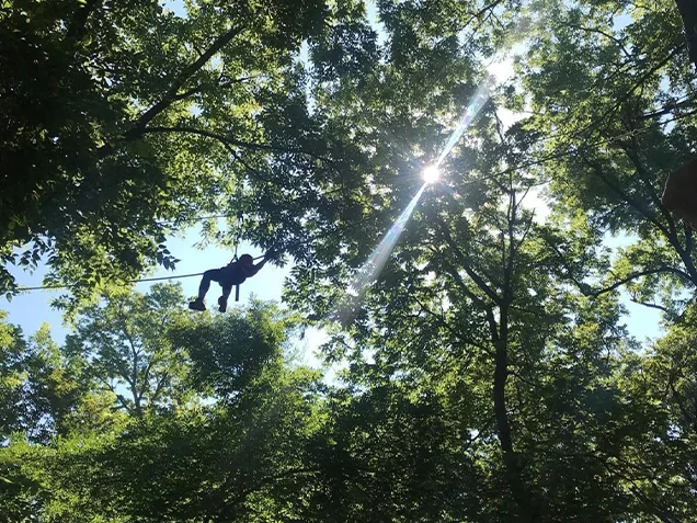 Climber ziplining at Go Ape zipline Omaha-Lincoln