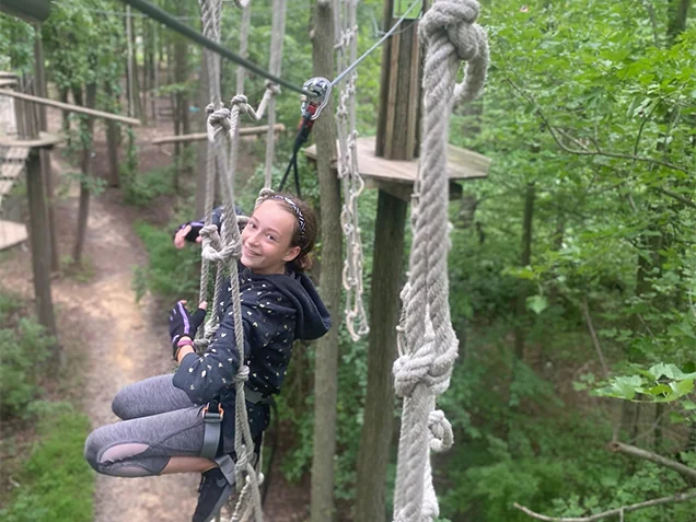 Girl having fun on Go Ape outdoor adventure ropes course Bear, Delaware