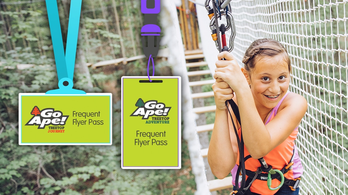 Young girl clutches her safety lines while navigating a treetop bridge obstacle
