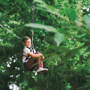 Young boy enjoying a zipline