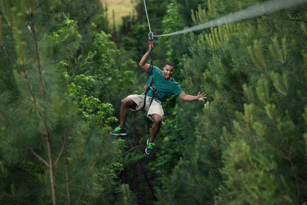 Man ziplining through the trees